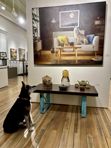 Alyn and Kevin West’s dog, Mädi, strikes a pose similar to the coyote in “Luna 2” by Aaron Morgan Brown, a SNW Gallery featured artist.