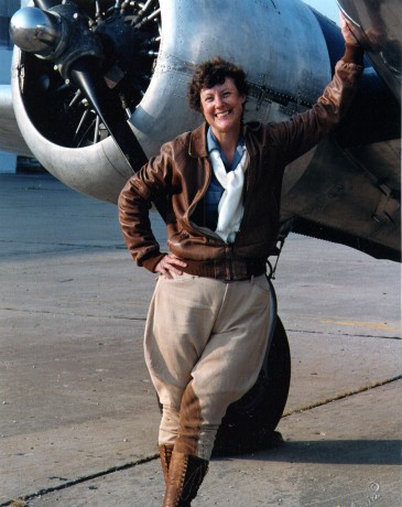 Ann Birney as Amelia Earhart standing in front of a Twin Beech SNB at the Combat Air Museum in Topeka, Kan.