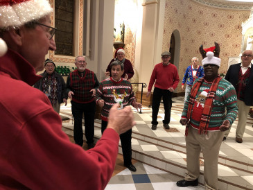 Jim Gardner, John Thomason, Denver Marlow, Tom Neil, Gary Mott, Chuck Marr, Harry Kindle, Keith Eyestone were among the Little Apple Chorus members who filmed two holiday favorites at Seven Dolors Catholic Church.