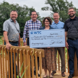 Wamego Telecommunications Company representatives met with members of Meadowlark’s leadership team to present a donation to support this year’s Paving the Way campaign. Standing on one of the Loop Trail bridges is (from left) Lonnie Baker, Meadowlark CEO;
